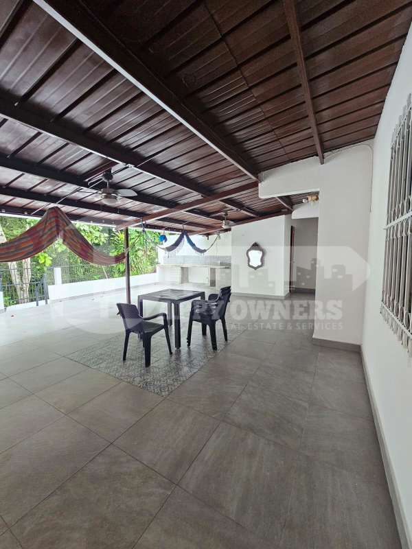 Spacious covered terrace with hammock outdoor kitchen perfect for relaxing at Villa de las Fuentes Betania
