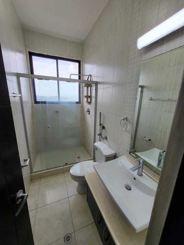 Modern bathroom with glass-enclosed shower and window PH Pacific Hills Dos Mares Panama