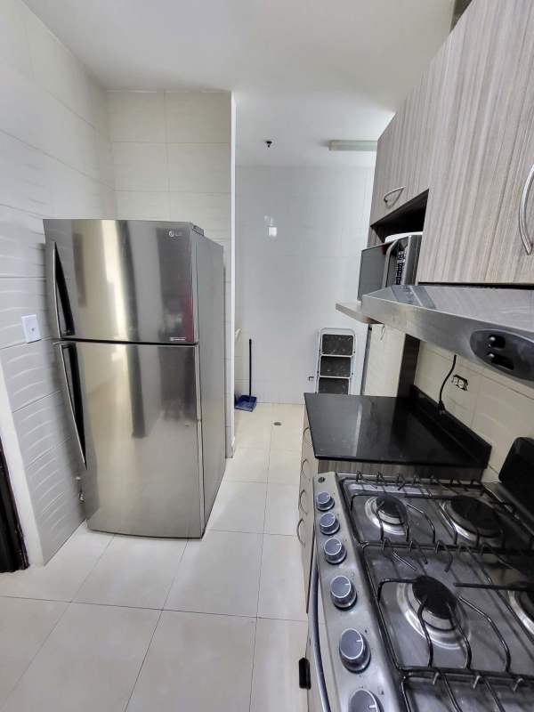 Laundry room with stacked washer, dryer, window, and storage PH Pacific Hills Dos Mares Panama