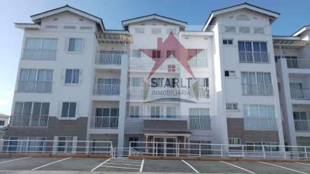 Modern three-story condominium complex facade with balconies and parking area PH Vista Azul Panama