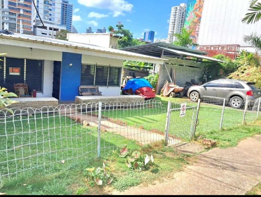 City residential street with single-story house and fenced yard Panama