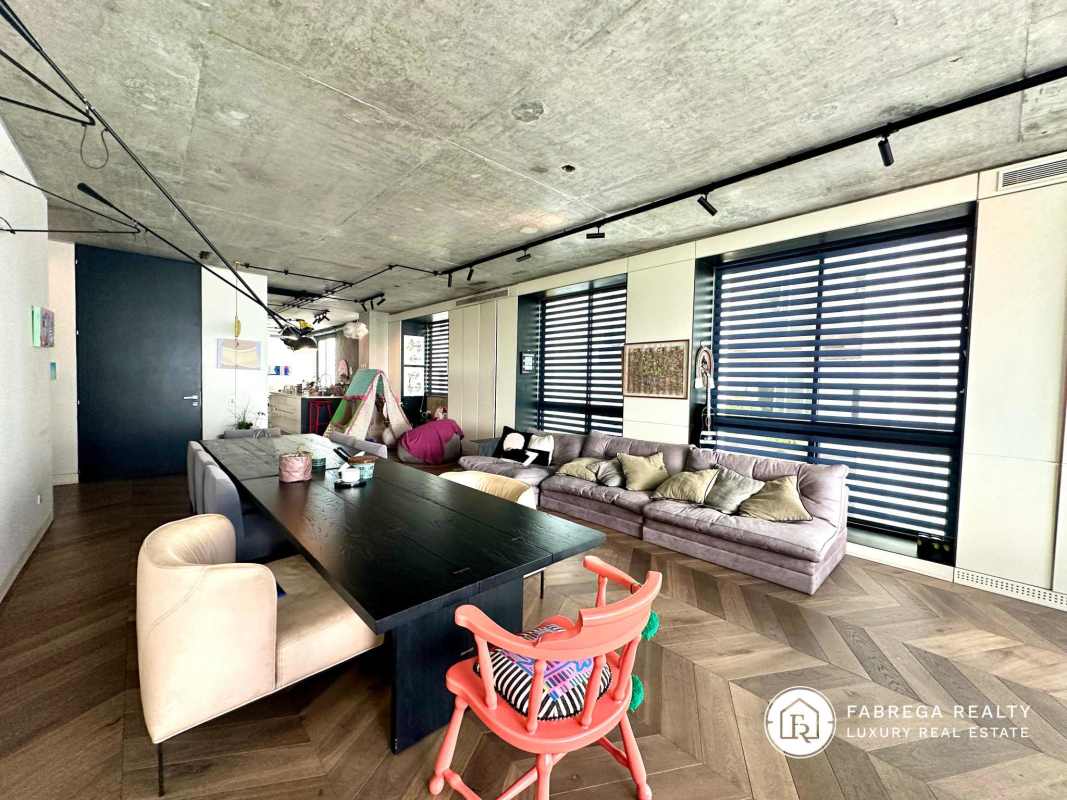 Open living-dining with concrete ceiling, large windows, wood flooring Premier Loft Panama