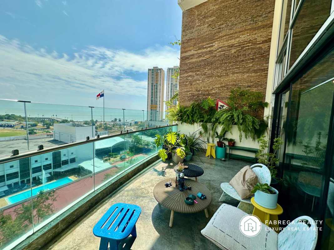 Modern balcony terrace with outdoor furniture, panoramic ocean skyline views Premier Loft Panama