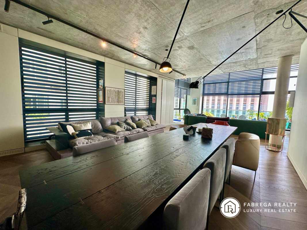 Modern open plan lounge and dining area with large windows city view Premier Loft Panama