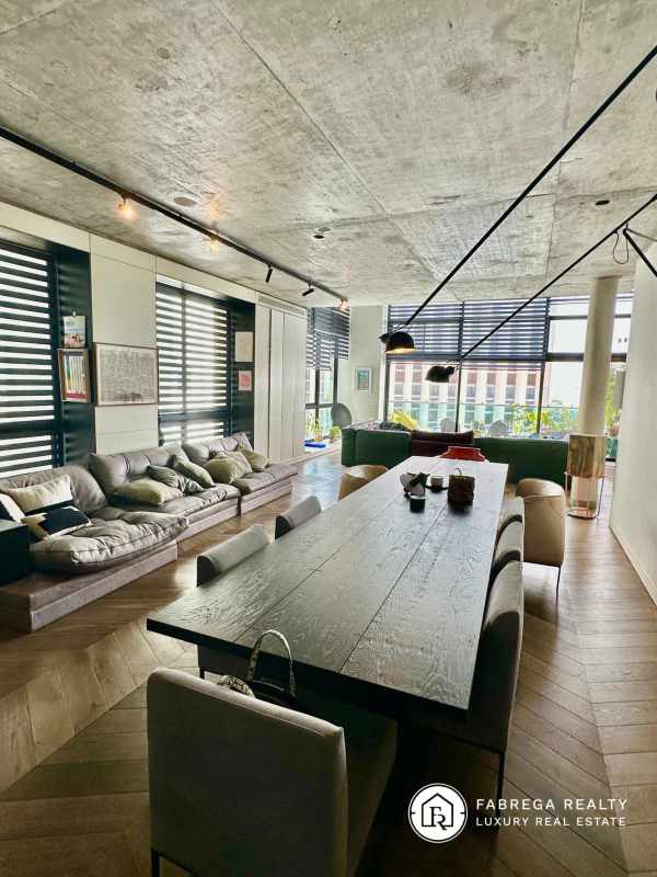 Industrial loft living dining with wood floors, concrete ceiling, view Premier Loft Panama