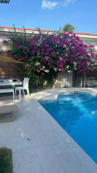 Covered terrace gazebo next to pool with BBQ lounge area in Nueva Gorgona beach house