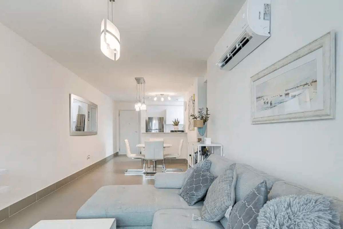 Fully equipped kitchen with granite counters, white cabinetry and stainless appliances in PH Altamira Residences Bella Vista Panama