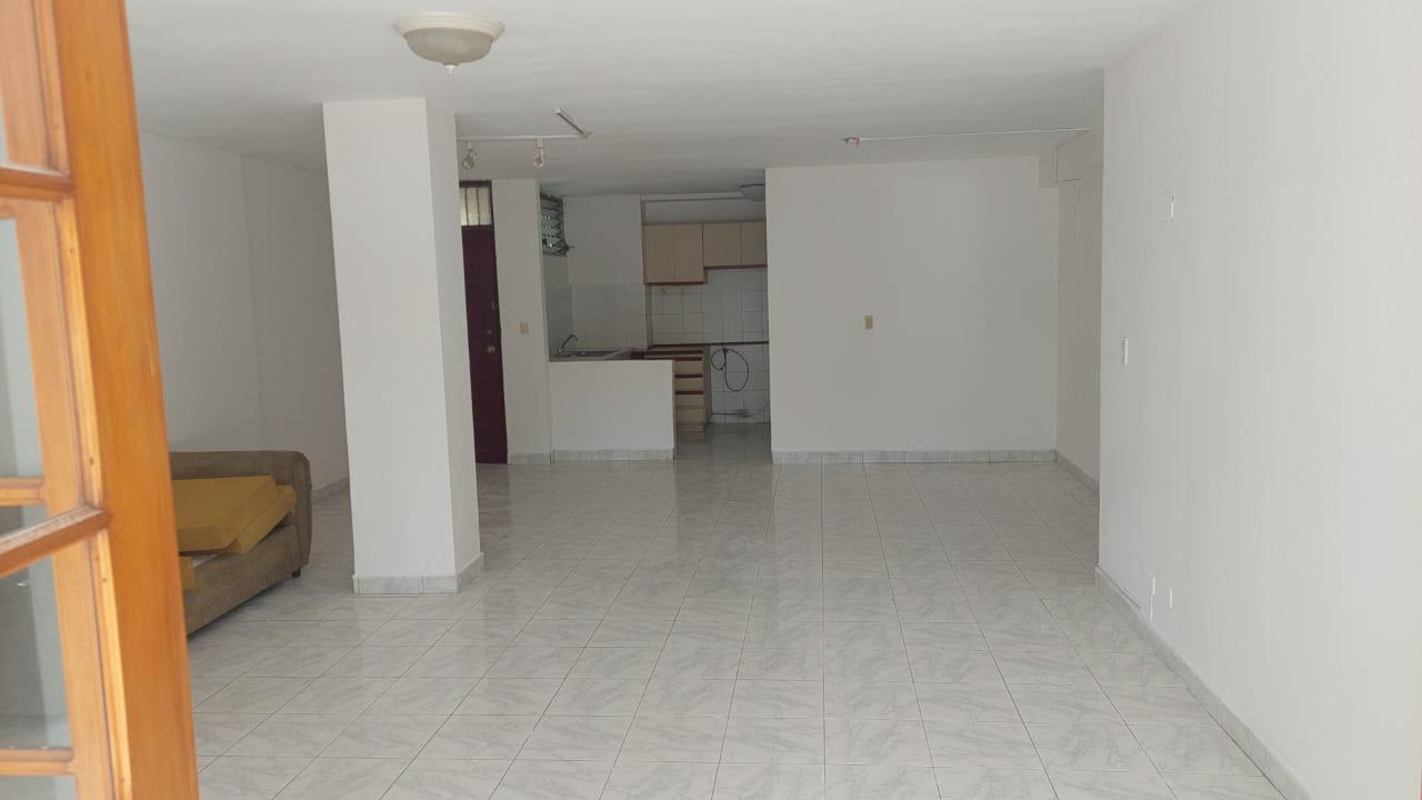 Spacious open-plan living dining area with balcony access ceramic tile PH Luz Vía Porras Panama