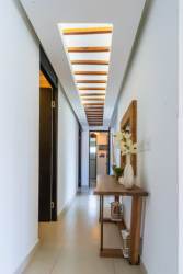 Bright bedroom with blue bedding, large window, modern beach decor in PH Rio Mar Villages Panama