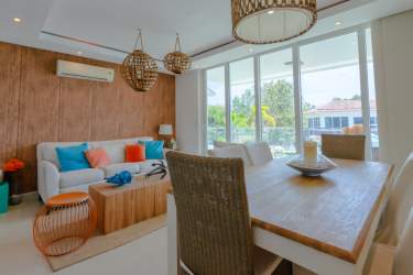 Open plan living dining space with balcony and garden views in PH Rio Mar Villages San Carlos Panama