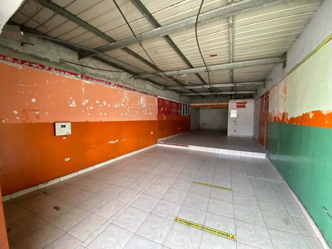 Commercial interior with tile flooring orange and green walls exposed ceiling Pedregal Panama