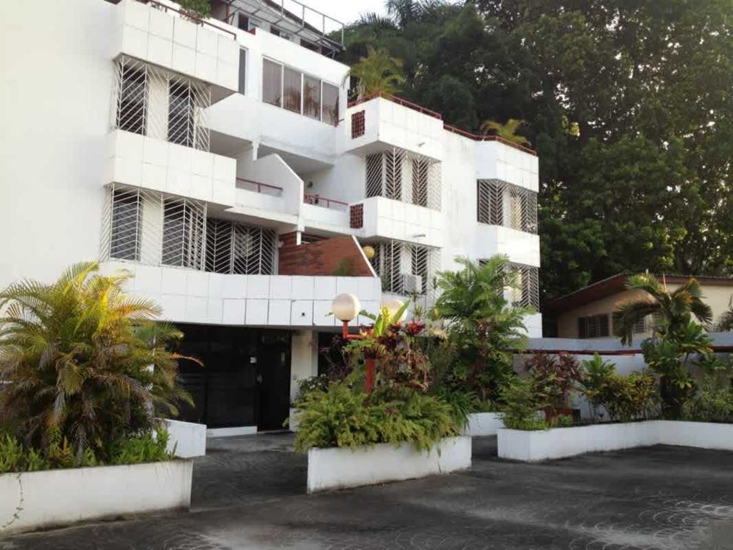 Multi-story residential building PH Royal Plaza with balconies and street parking El Carmen Panama