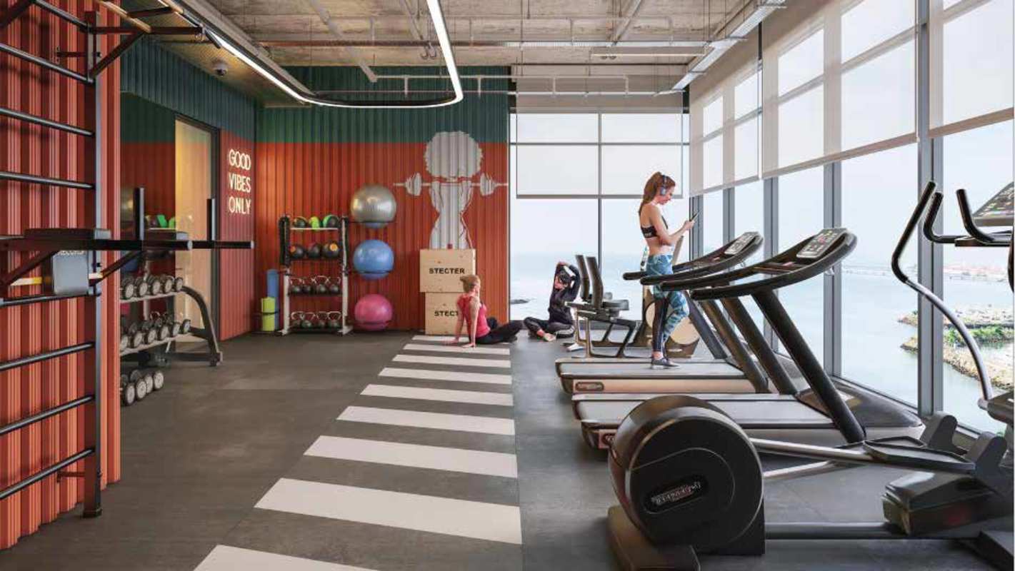 Lobby with wood accent wall, reception desk, seating in PH Armonía Bella Vista Panama