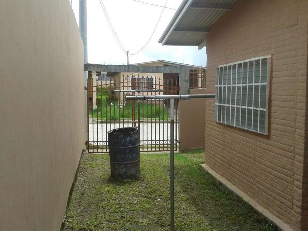 Rear wall with metal barred windows and security fencing Villa Zaita Panama rental