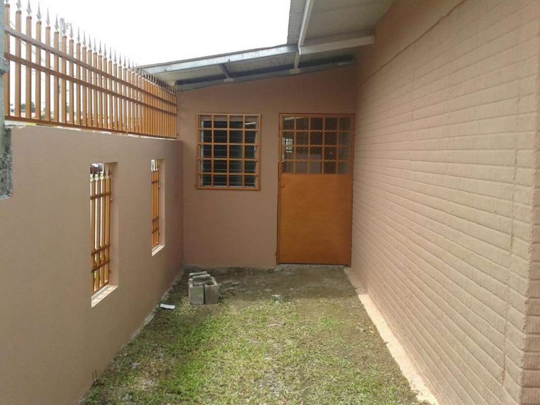 Secured entryway with metal doors and barred window at Villa Zaita rental home Panama