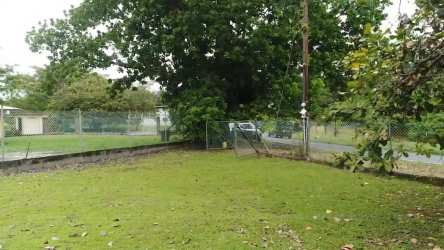 Large fenced yard with trees and gate in Nueva Gorgona Panama investment property