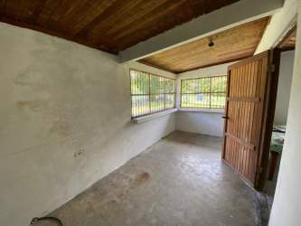 Aerial of triangular land parcel with building and greenery adjacent to road Nueva Gorgona Panama