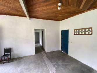 Interior living room with wooden ceiling cement floor blue doors Nueva Gorgona Panama