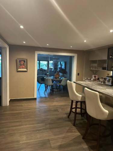 Kitchen with marble peninsula, modern cabinetry, open to dining in house San Francisco Panama