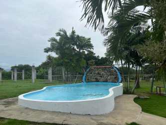 Rustic outdoor dining area with colorful mural at ecohotel farm for sale in San Carlos Panama