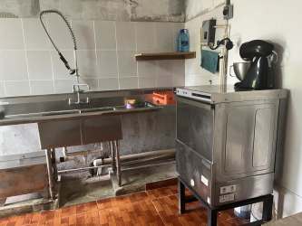 Patio and lounge with hammock, tables overlooking gardens at EcoHotel Finca Oasis in San Carlos Panama