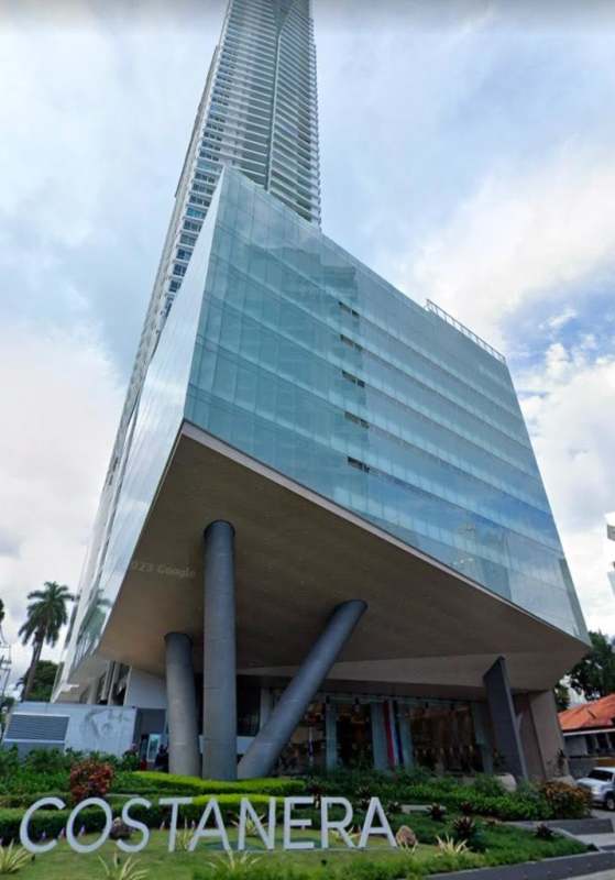 Urban balcony lounge with glass rail, stylish furniture and ocean backdrop PH Costanera Panama City