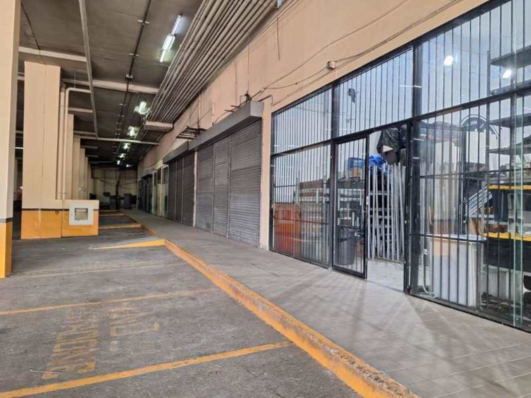 Large indoor parking and warehouse area with storage tanks in Victoriano Lorenzo Commercial Center