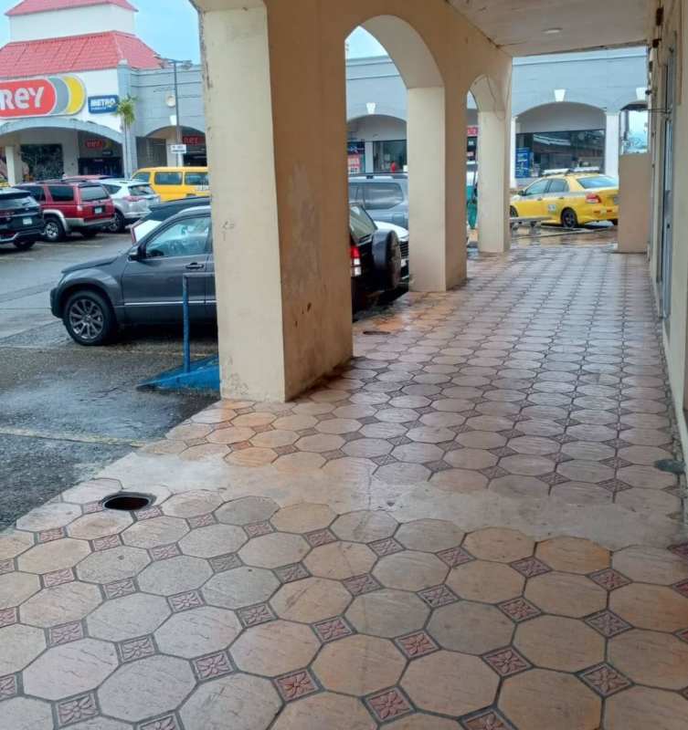 Glass facade of a commercial retail unit with signage and displays Plaza Mis Provincias Rufina Alfaro Panama