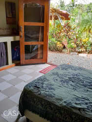 Eclectic bathroom with blue tiles, Jacuzzi tub and double sinks in Alto Boquete house