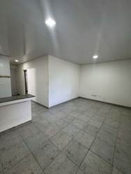 Traditional kitchen with granite counter, brown cabinets, tile backsplash inside Penonomé apartment for rent