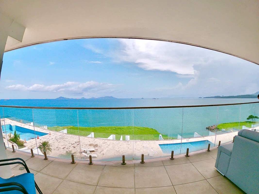 Spacious balcony with glass railings overlooking Pacific entrance Panama Canal in Amador causeway condo