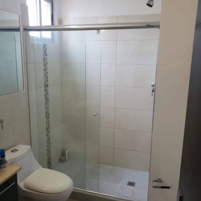 Modern bathroom with glass shower enclosure, mosaic accent tiles in PH Diamond Tower Panama City