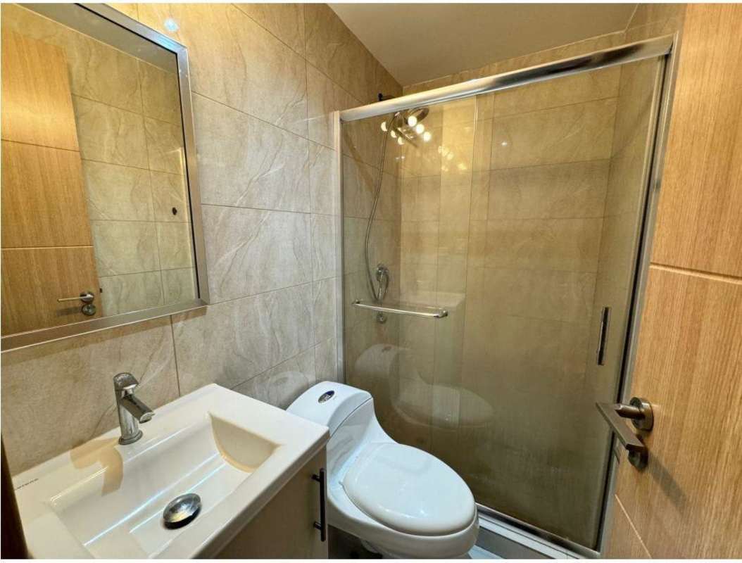 Modern bathroom with enclosed shower and vanity PH Vía Porras San Francisco Panama