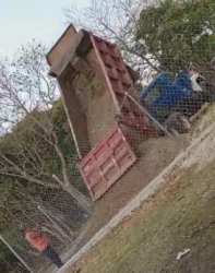 Dump truck unloading soil fenced countryside property Penonomé Panama