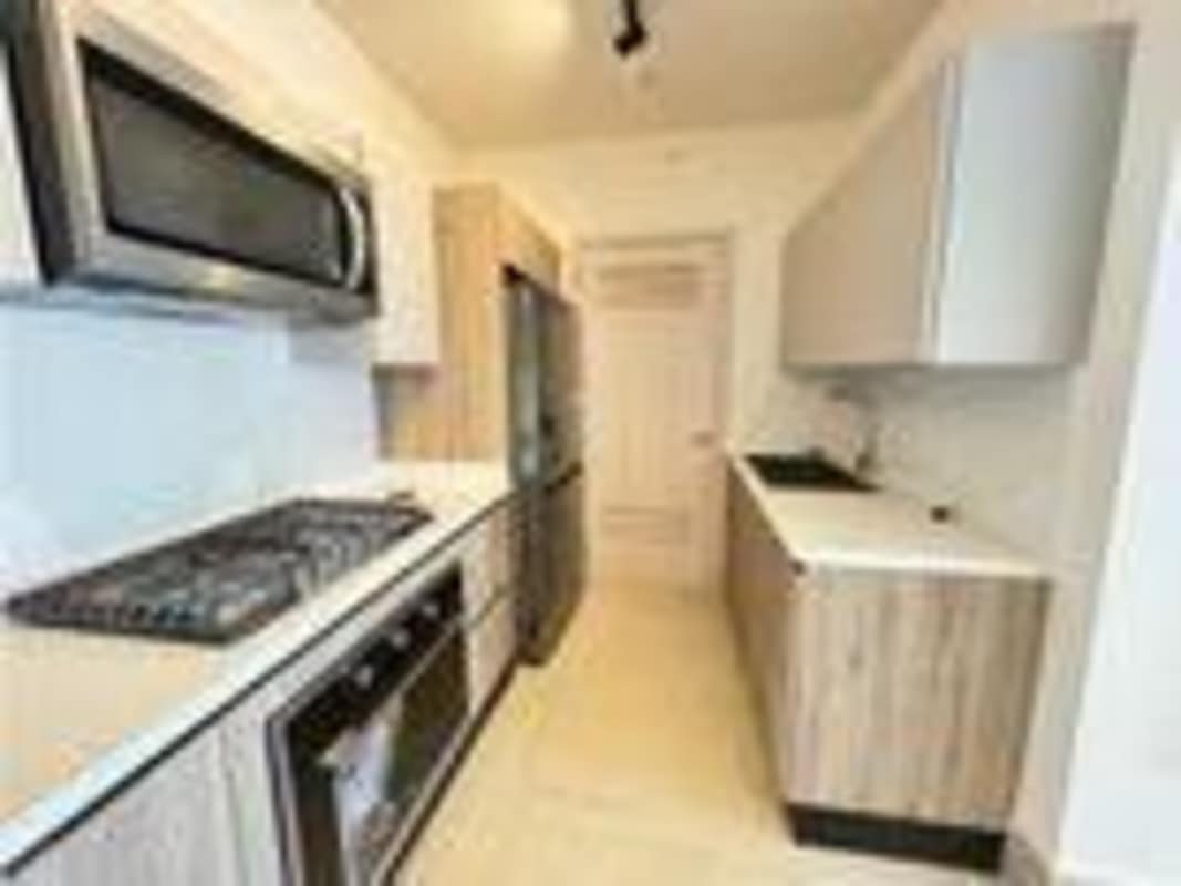 Galley kitchen with stainless appliances and contemporary cabinetry Santa Maria Panama