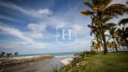 Tropical beachfront view with palm trees, ocean and lush gardens at Puntarena Beach Club Buenaventura Panama