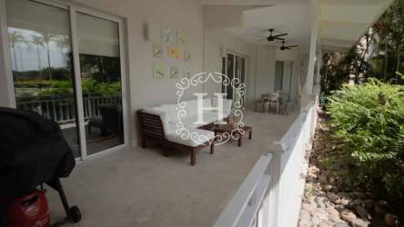 Covered outdoor terrace with lounge and dining area overlooking lush gardens at Buenaventura Puntarena