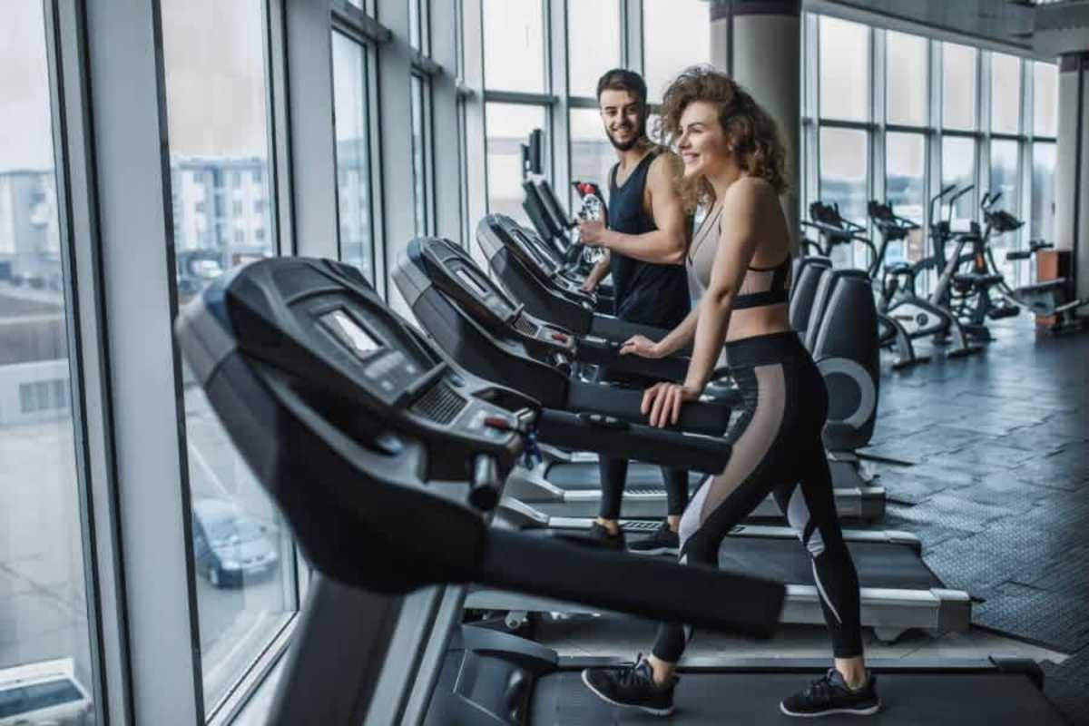 Bright modern gym with cardio machines large windows skyline views PH Alexa Panama City