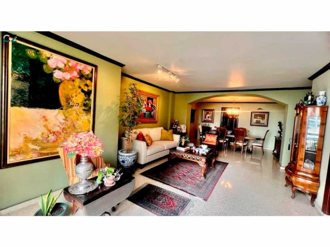 Large kitchen with wood cabinets, gas stove, white countertops, traditional details in Marbella Panama