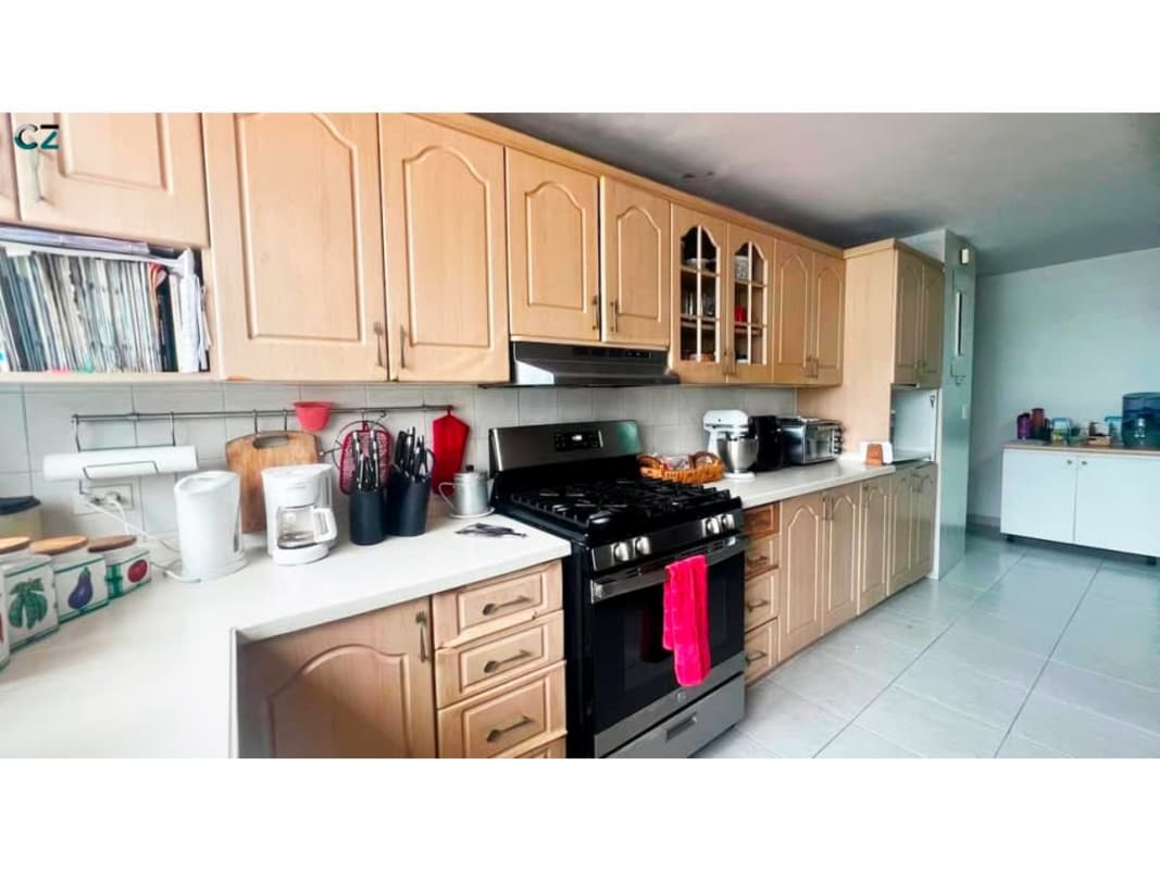 Kids bedroom with large windows, teal sofa, colorful decor, AC and fan in Marbella Panama