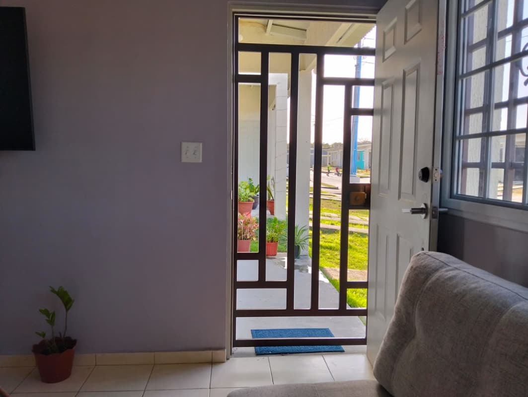 Backyard patio area with barred windows, utility sink and garden plants Altos del Azul Cabra Panama