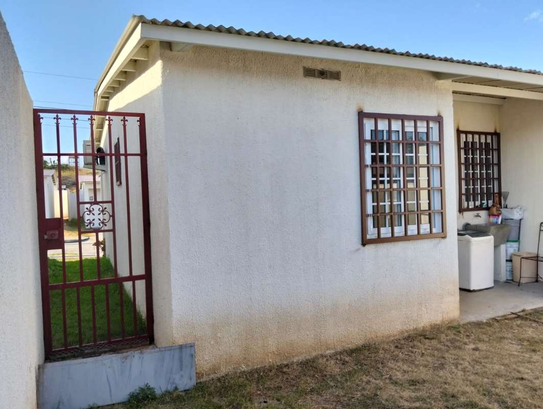 Light filled living dining area with sofa, tiled floor, TV stand and granite kitchen counter rental Cabra Panama