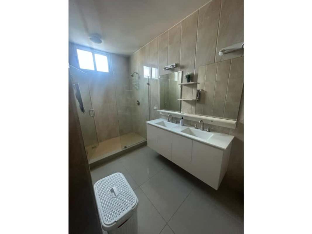 Spacious bathroom with double sink vanity and glass shower enclosure PH Top Towers Costa del Este Panama
