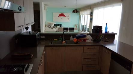 Bright living and dining space with balcony access at PH Bijao Residences Balboa II Panama beach condo