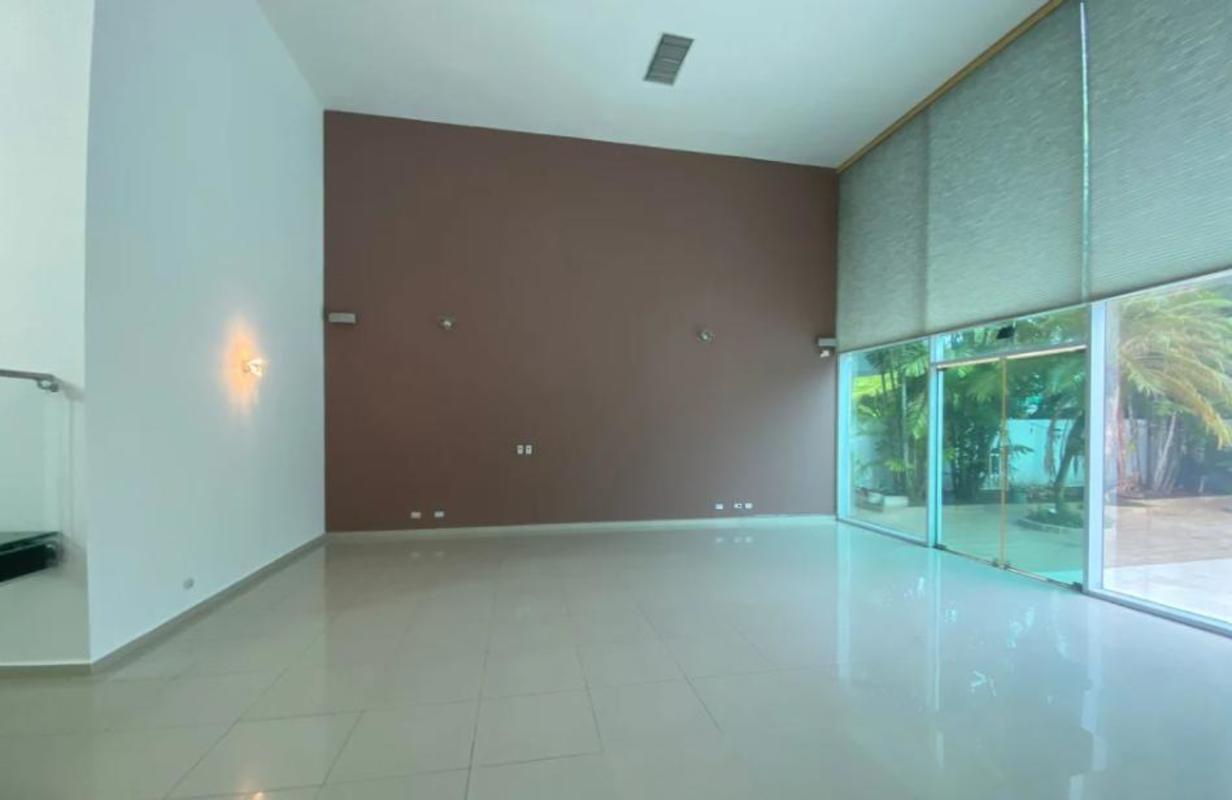 Spacious living area with high ceilings double height windows in Costa Sur rental villa Panama