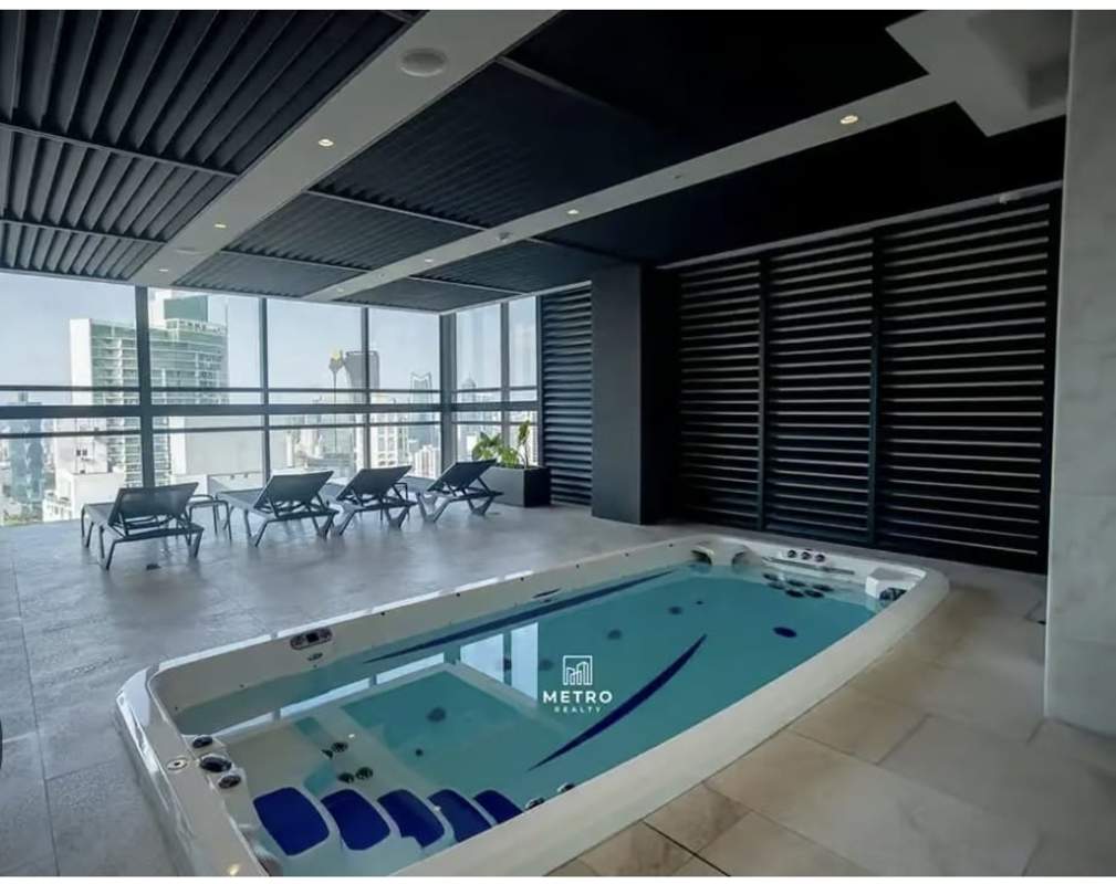 Contemporary indoor spa pool with lounge chairs at Nuovo by Armani Casa Panama City
