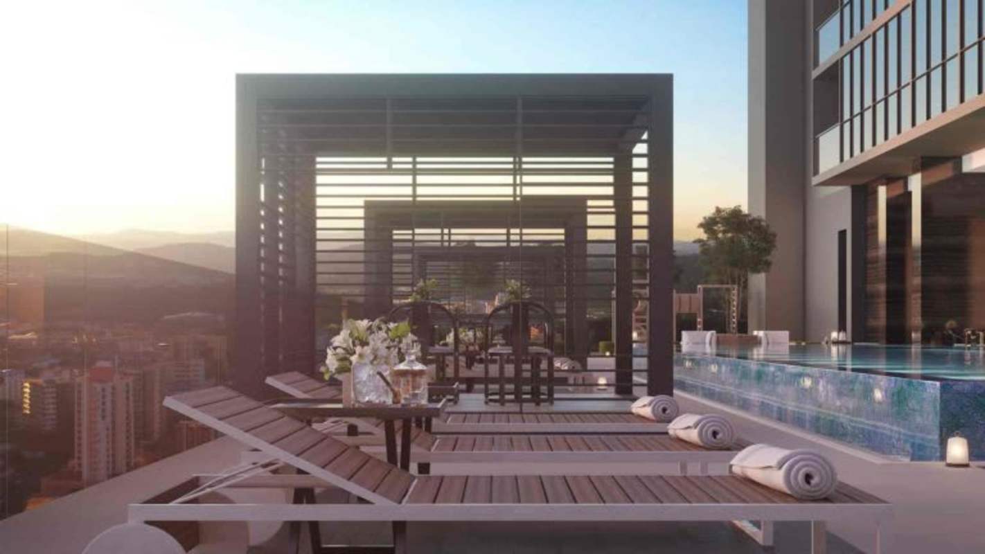 Infinity rooftop pool with cabanas and lounge chairs city view Nuovo by Armani Casa on Avenida Balboa