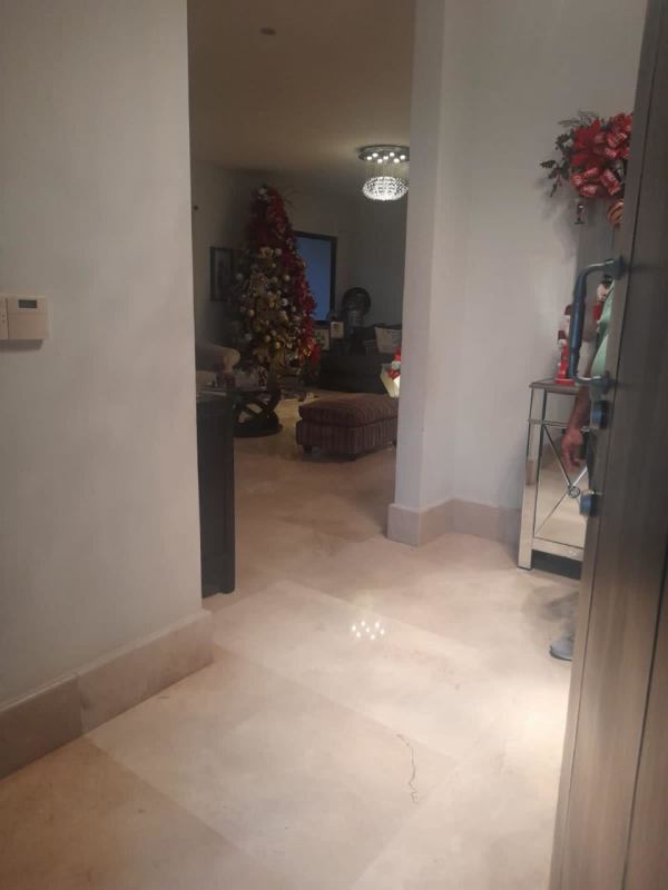 Entrance hallway with marble floor, chandelier, Christmas decor luxury house El Carmen Panama City