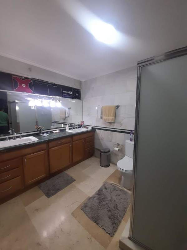 Spacious kitchen with wooden cabinetry, granite countertops in luxury house El Carmen Panama City