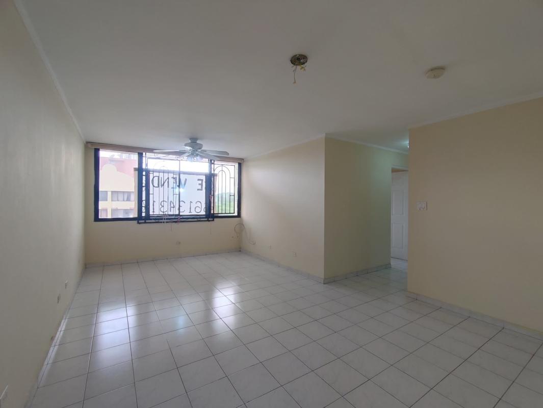 Spacious tiled living room with large window and ceiling fan PH Villa Gloriela Panama City